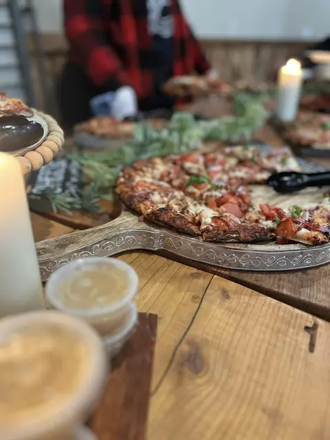 Pizza on a serving board at a catered table