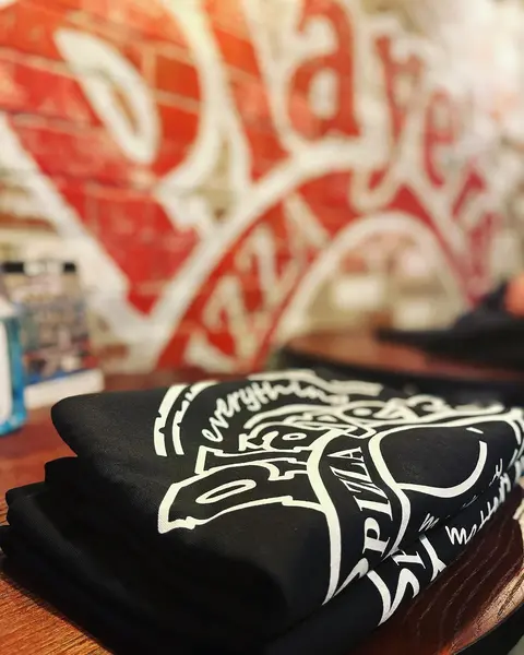 Folded black Players Pizza t-shirts