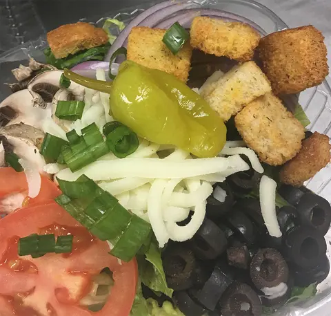 Salad with croutons, pepperoncini, olives, tomato and mozzarella
